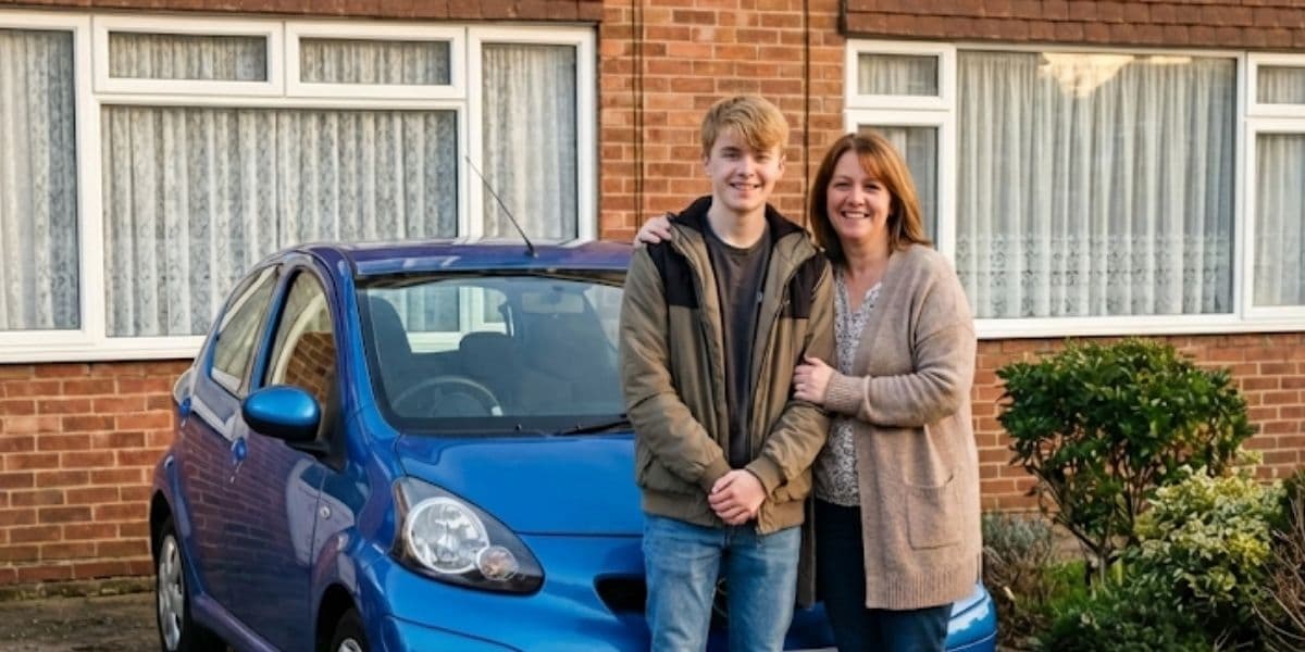 New driver and mother after passing driving test with blue Toyota Aygo
